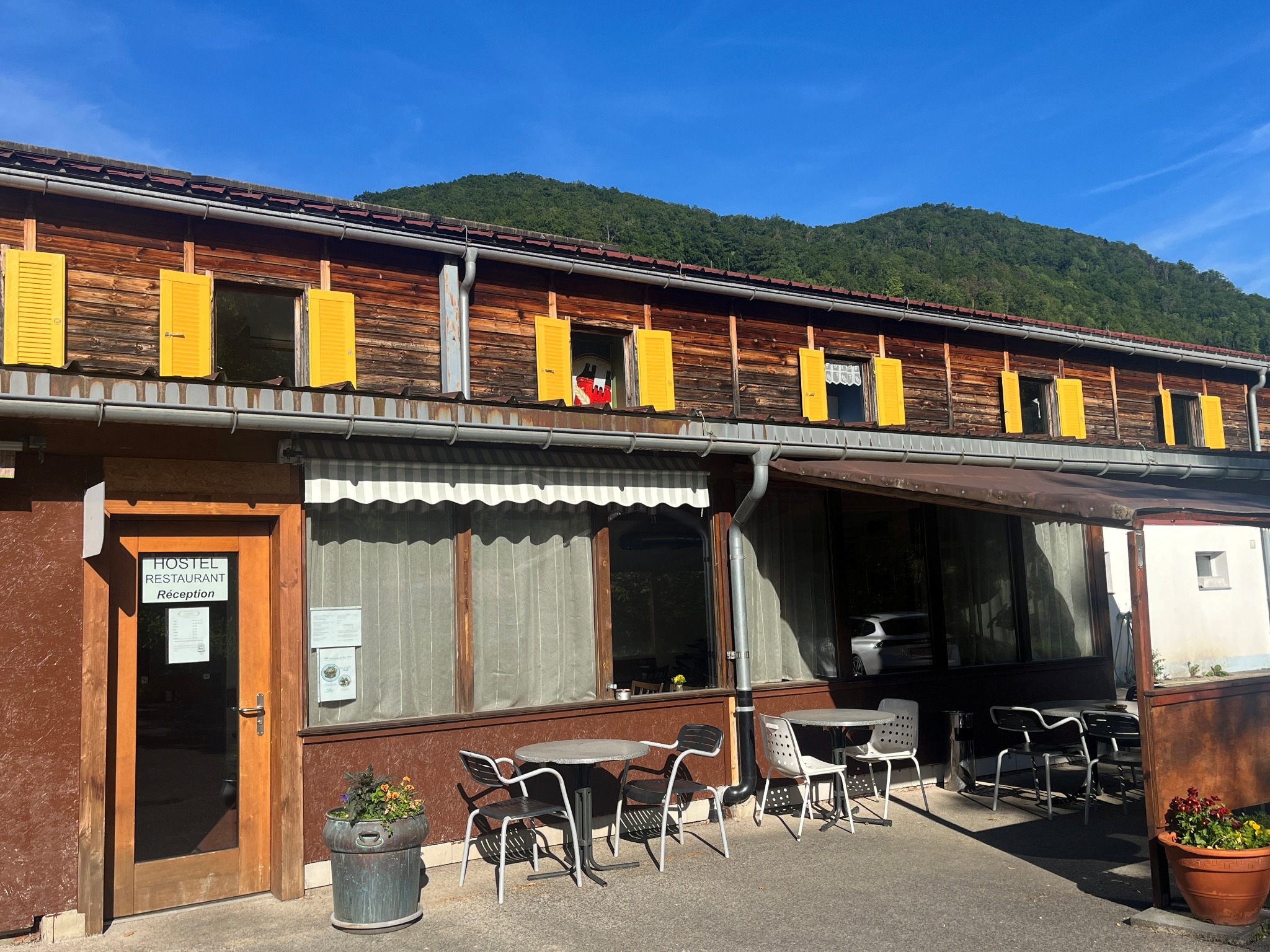 Le Chandelier Hostel building and terrace